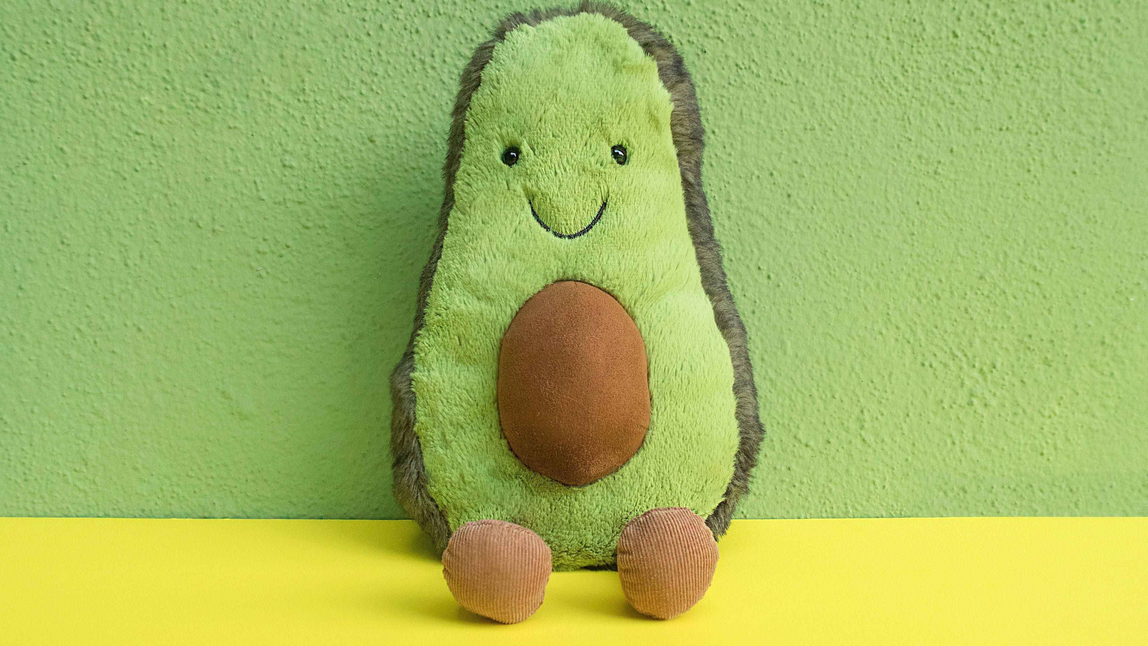 Avokado Opvul Speelding Op Pastelgroen Muurpapier