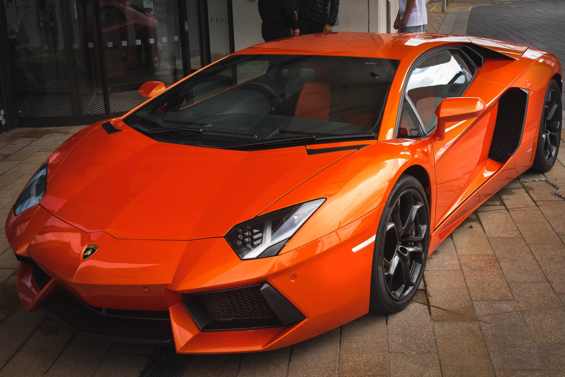 Oranje Lamborghini Aventador voor- en sykant-agtergrond.