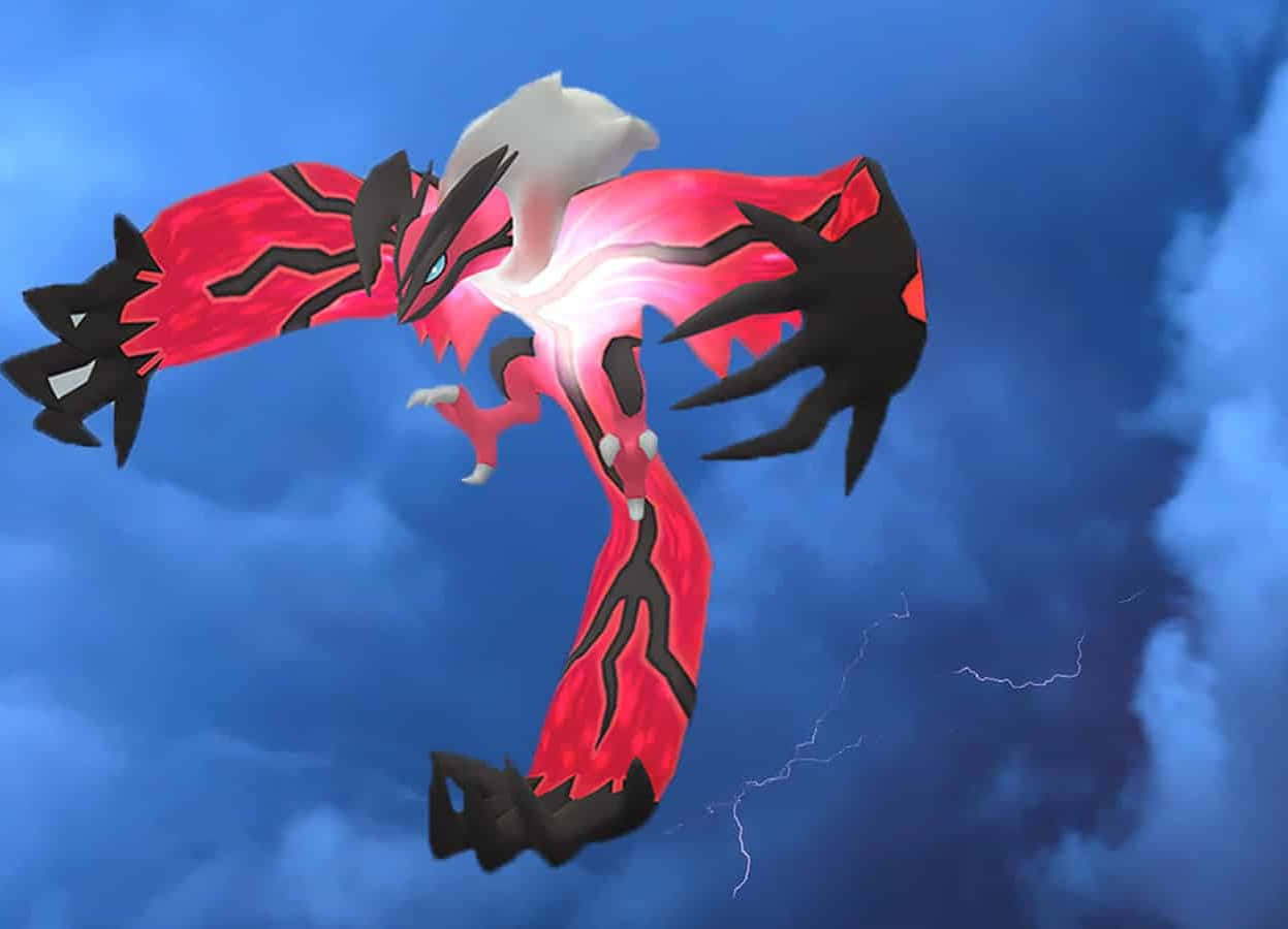 Gloeiende Yveltal Pokemon in die Lug Muurpapier