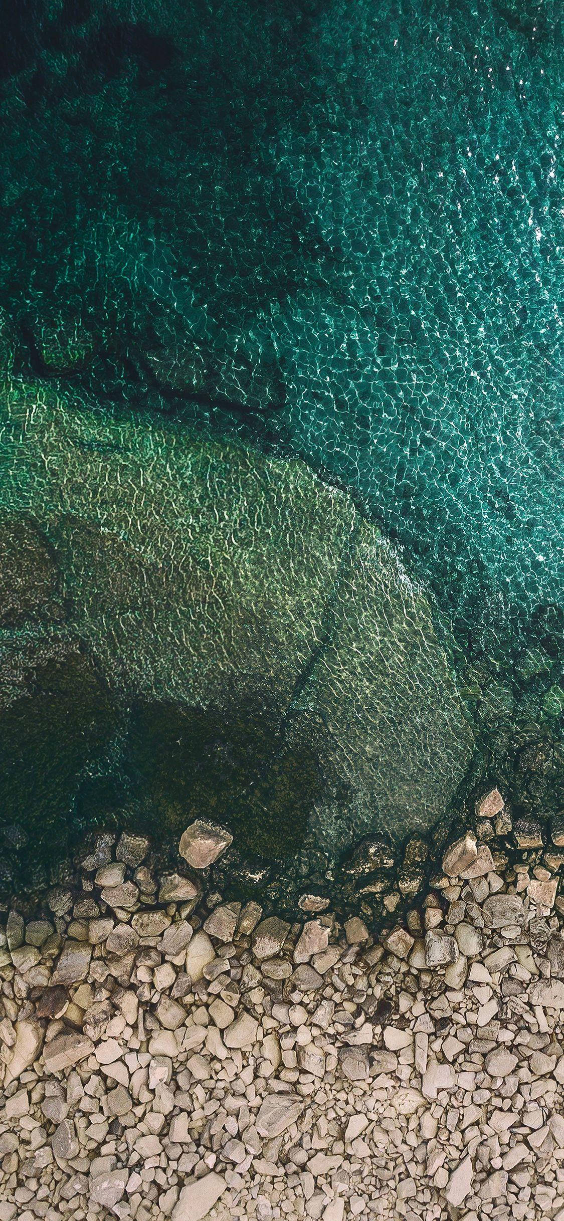 iPhone X Oorspronklike Klippies Op Strand Muurpapier
