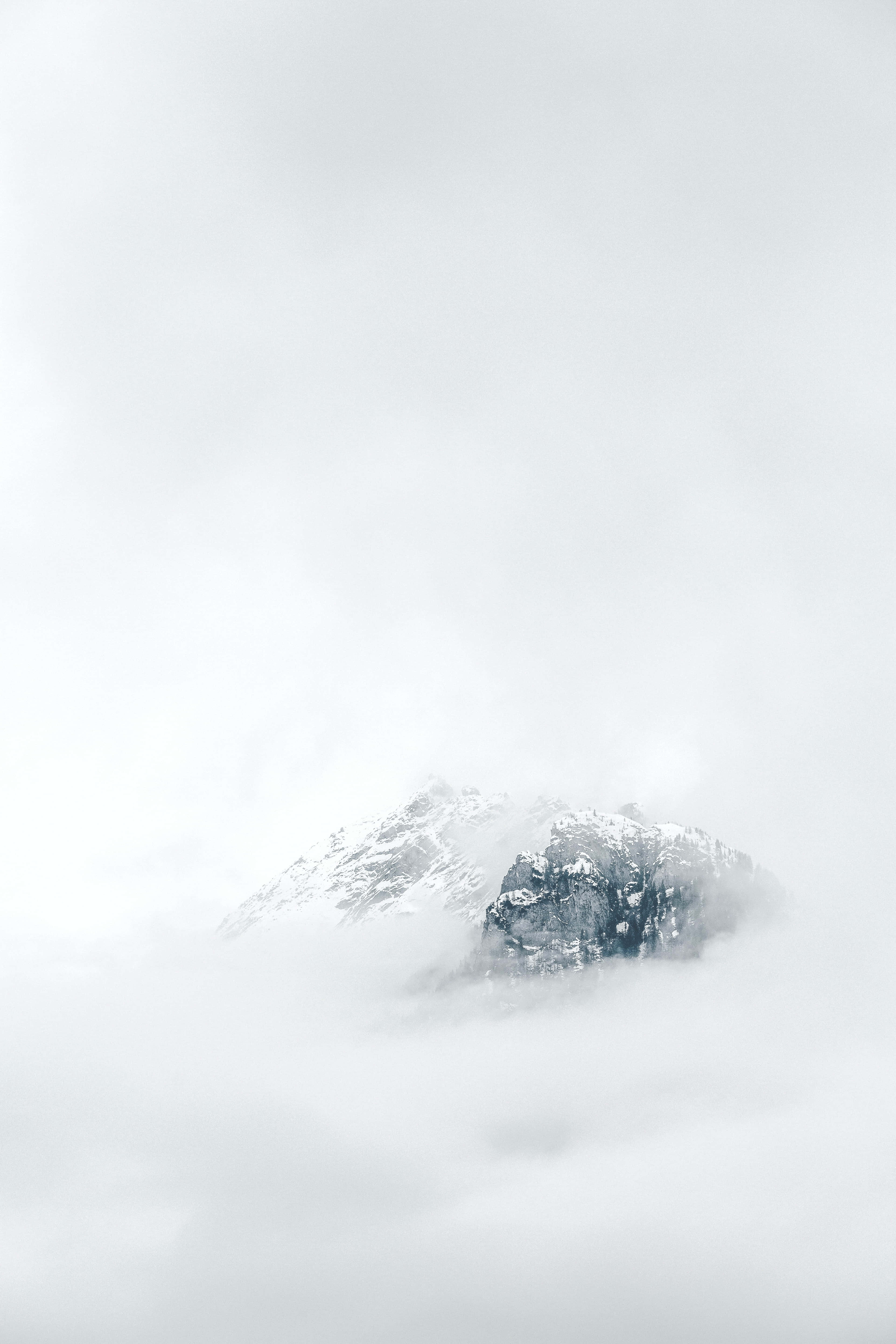 'n berg bedek met wolke met sneeu bo-op Muurpapier