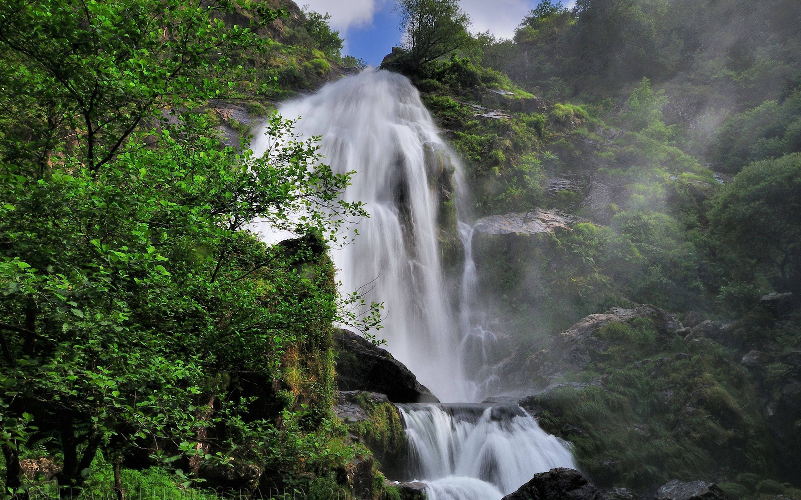 ’n Majestueuse Bergwaterval. Muurpapier