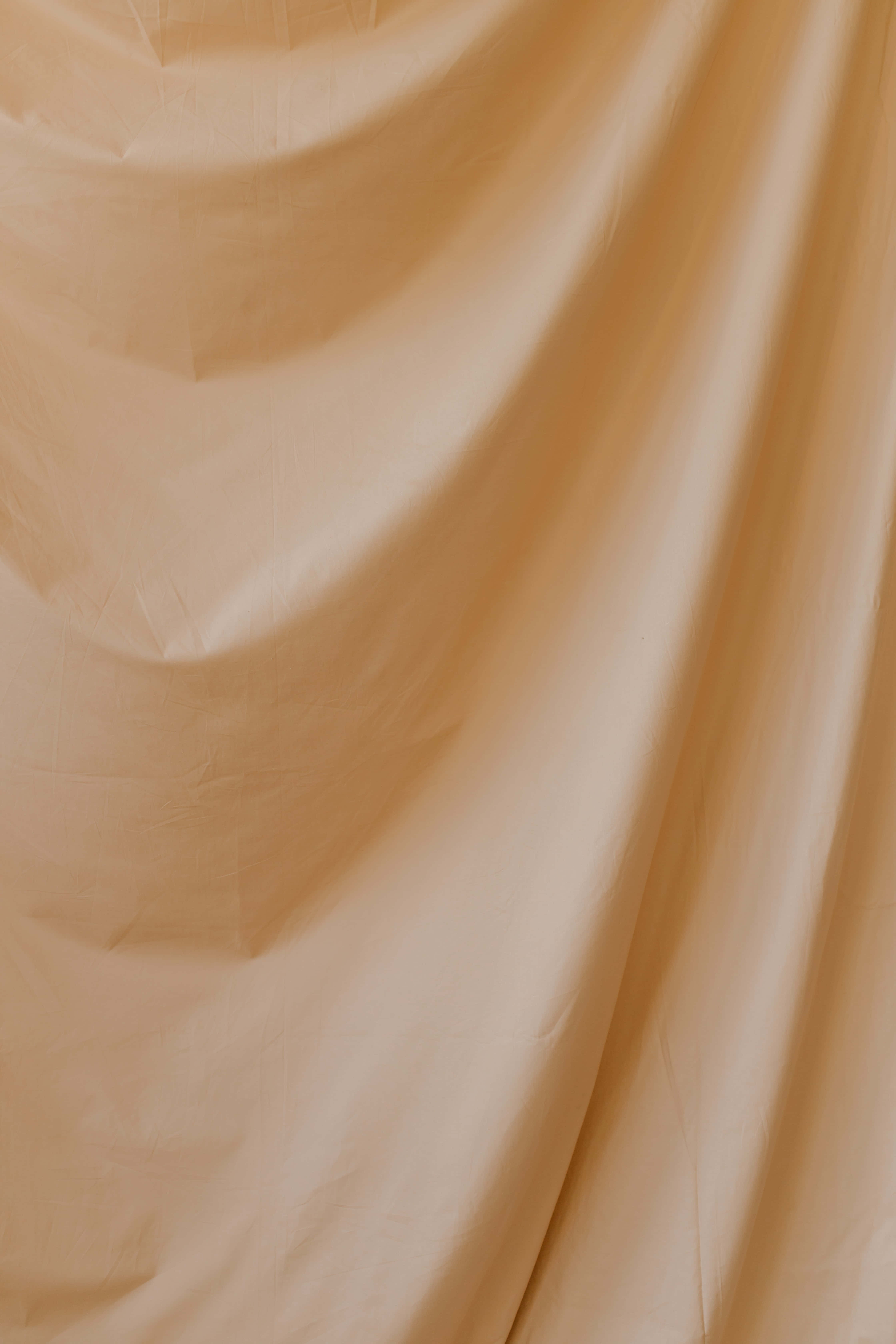 'n Nabyfoto van 'n beige materiaal Muurpapier