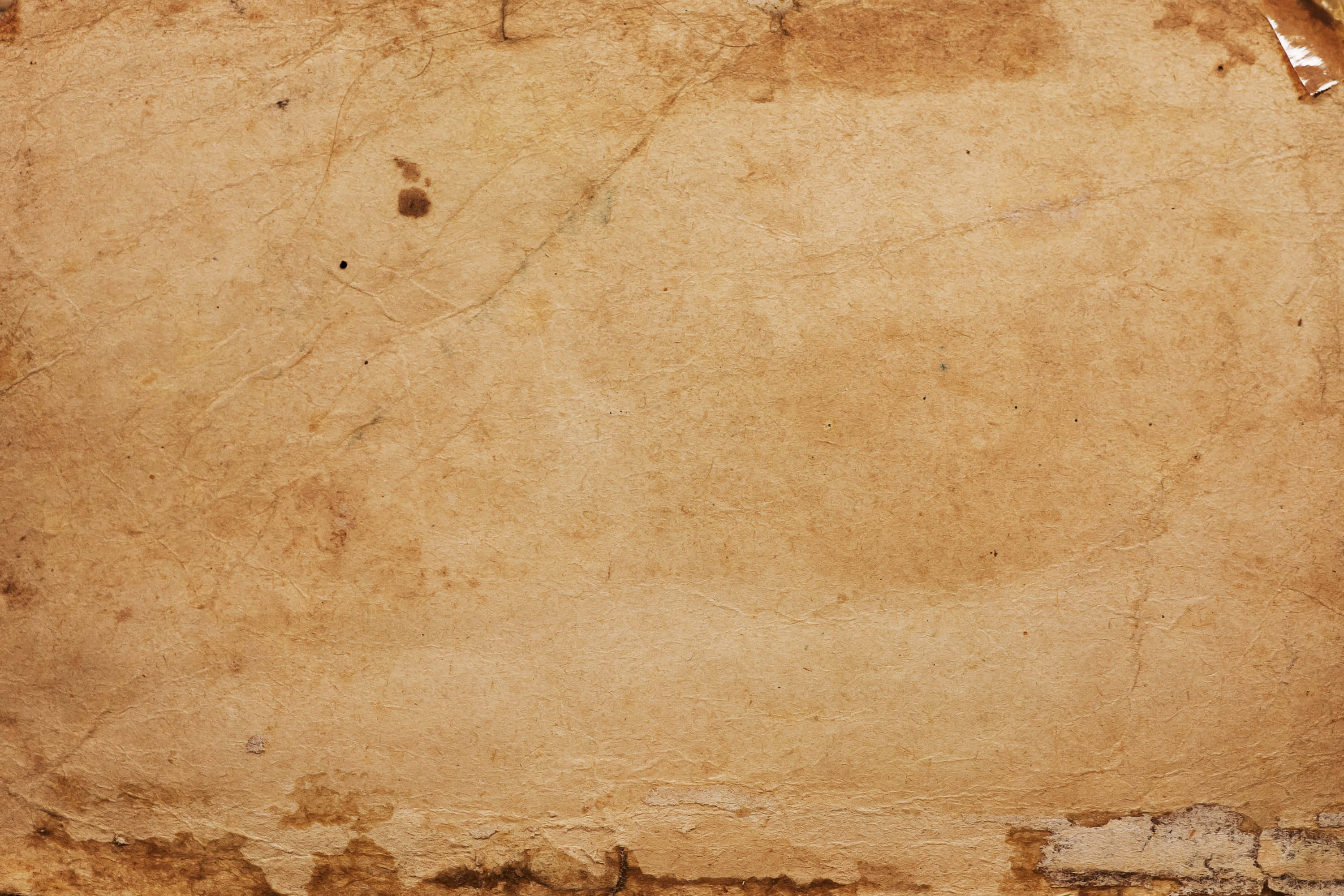 'n ou papier met 'n skeur daarin Muurpapier