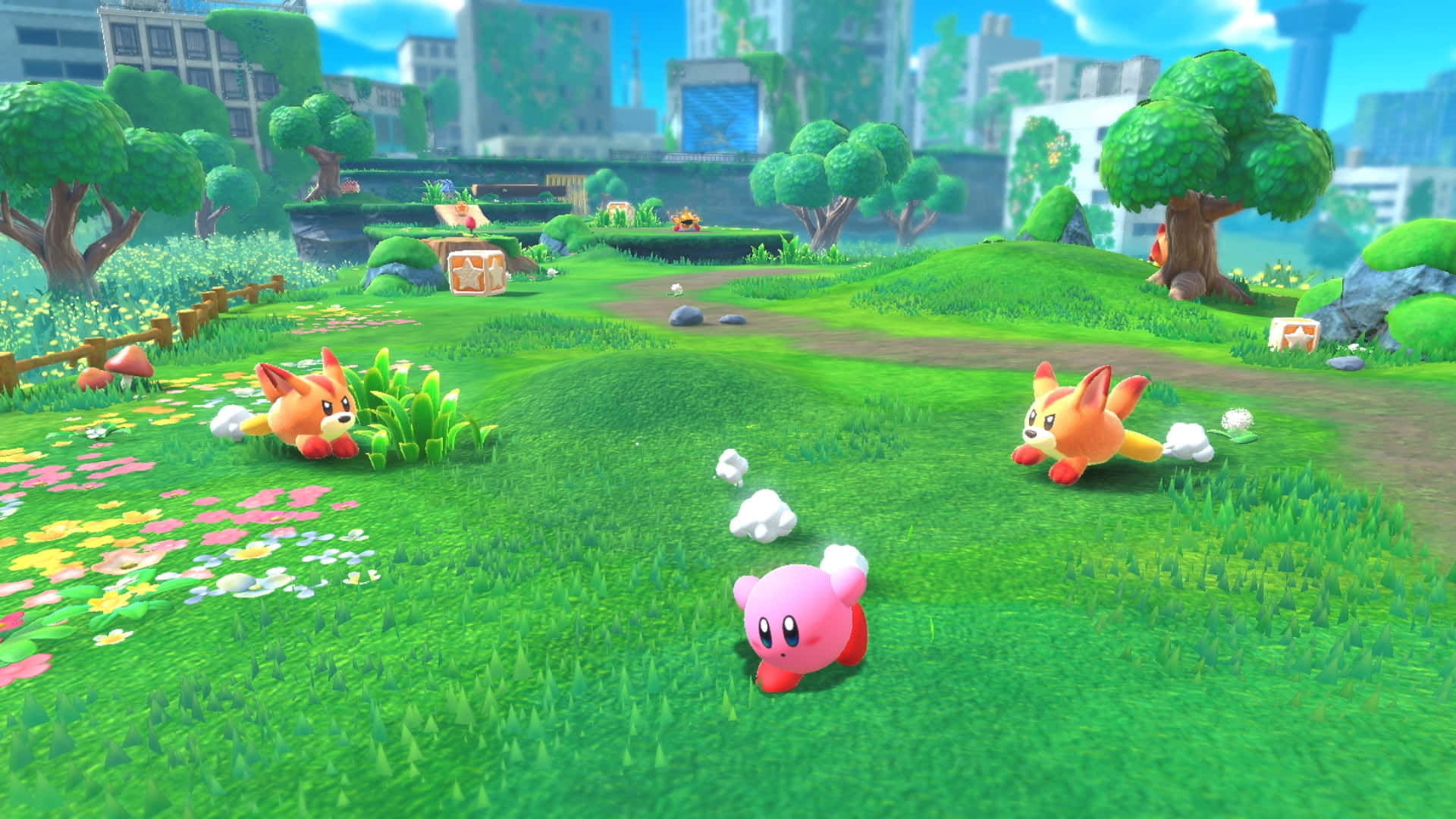 'n Oulike Kirby-karakter sit op 'n hoop kleurvolle sterre Muurpapier