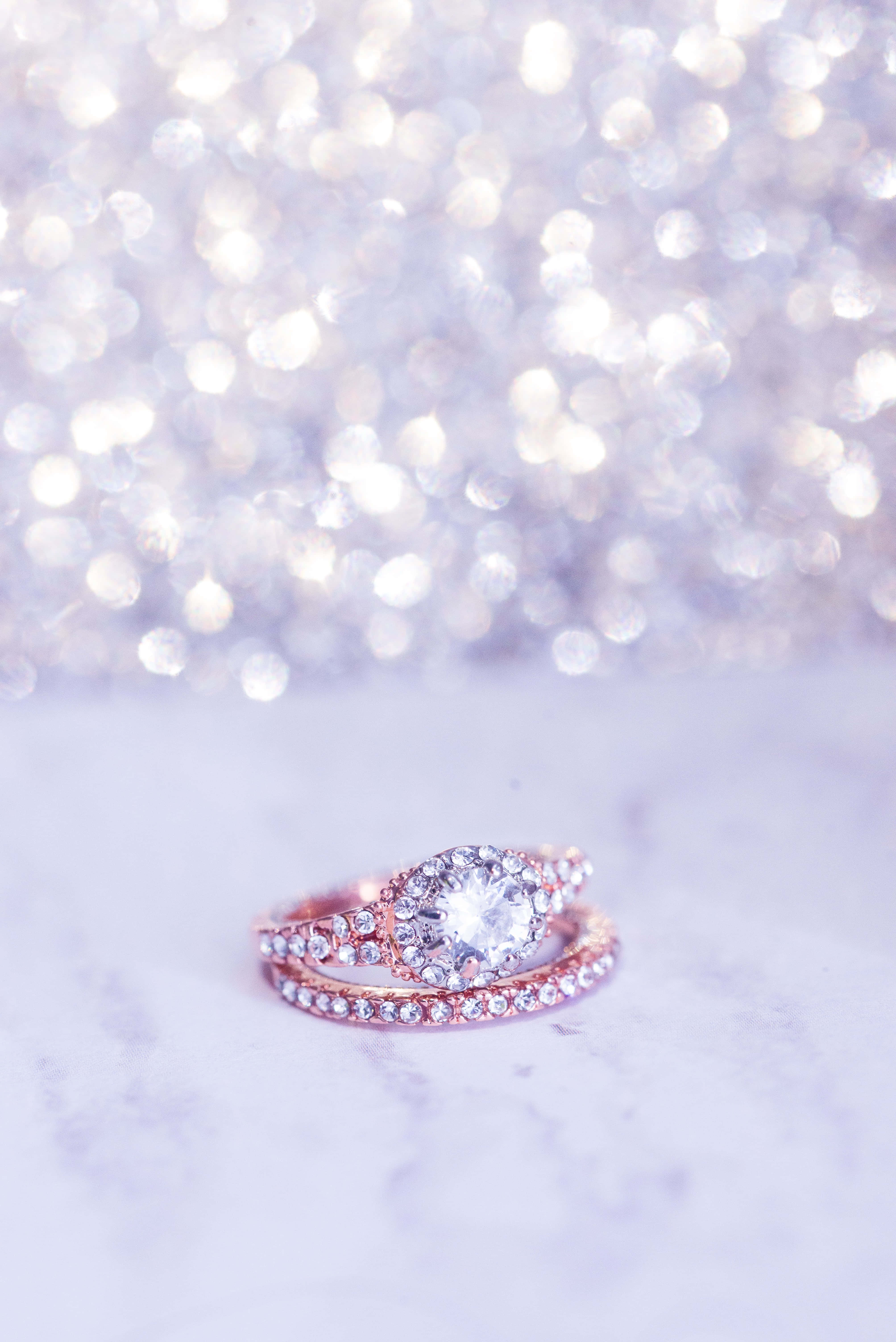 'n roosgoud-verlowingsring met 'n diamant in die middel Muurpapier