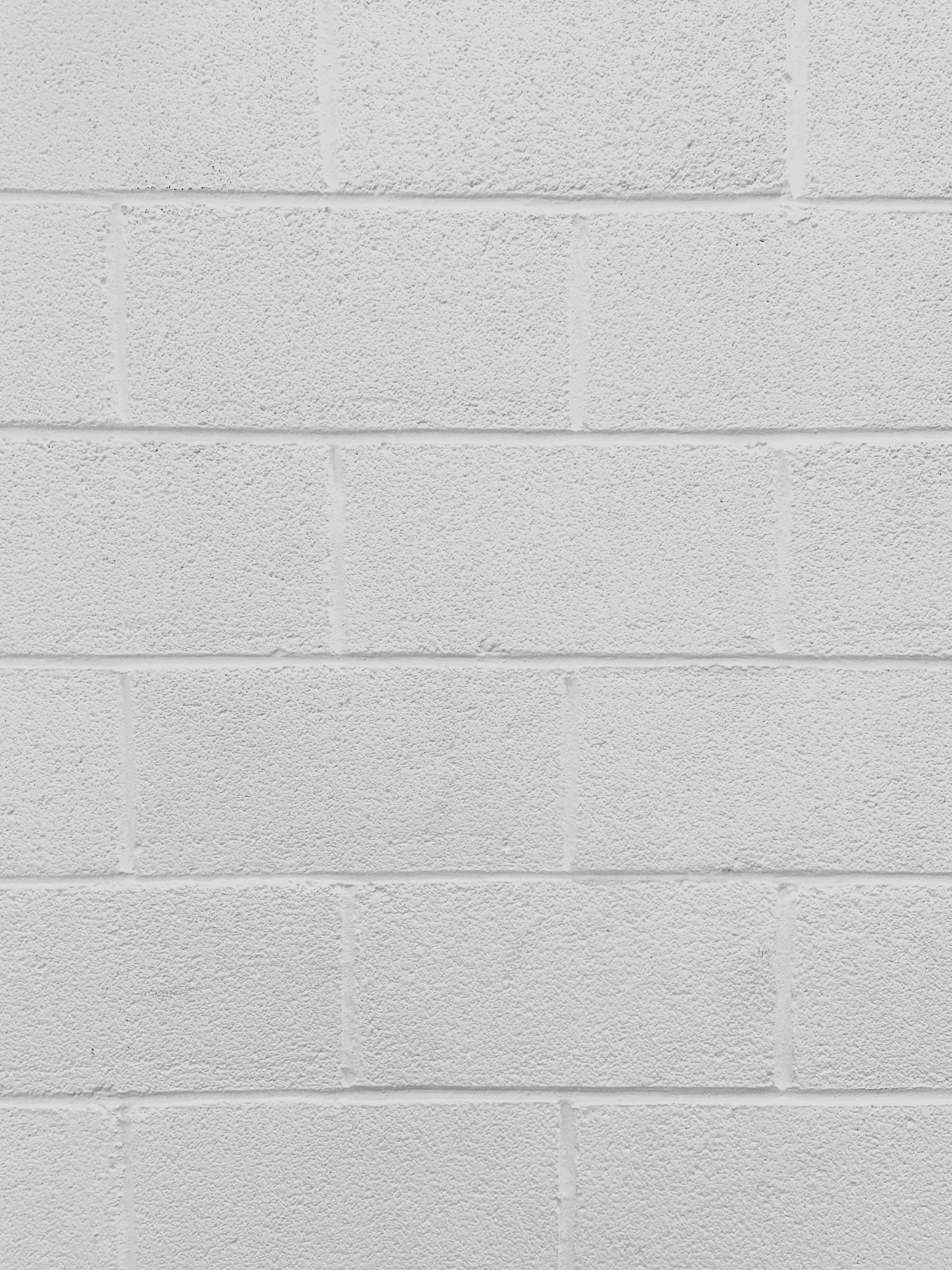 'n wit baksteenmuur met 'n wit baksteentekstuur Muurpapier