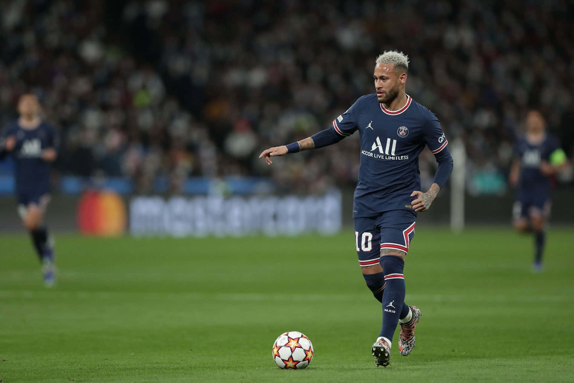 Neymar wat die bal verby 'n teenstander dribbel. Muurpapier