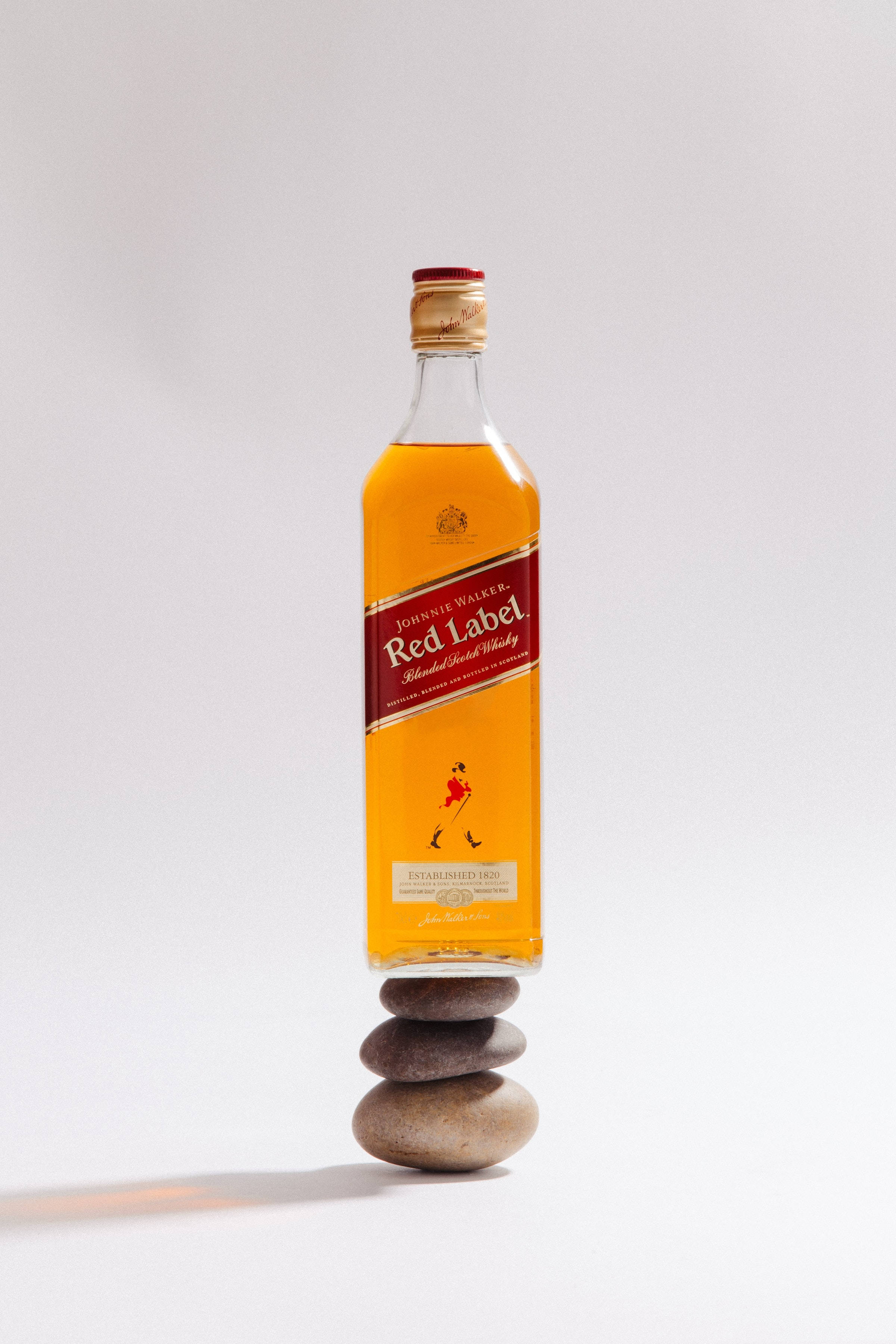 Red Label Whiskybottel op Klipstapel Muurpapier