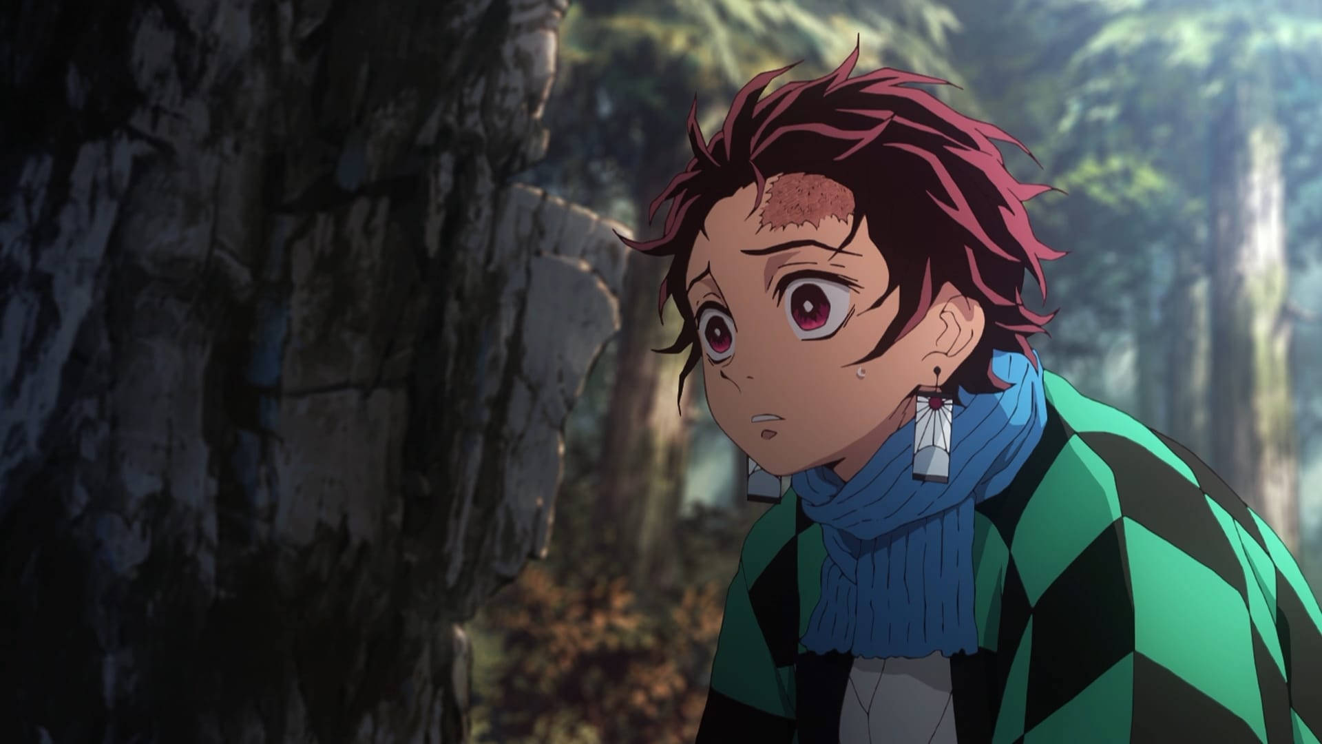 Demon Slayer-agtergrond van Kamado Tanjiro wat hartseer in die bos lyk. — Demon slayer 4K GIF Muurpapier