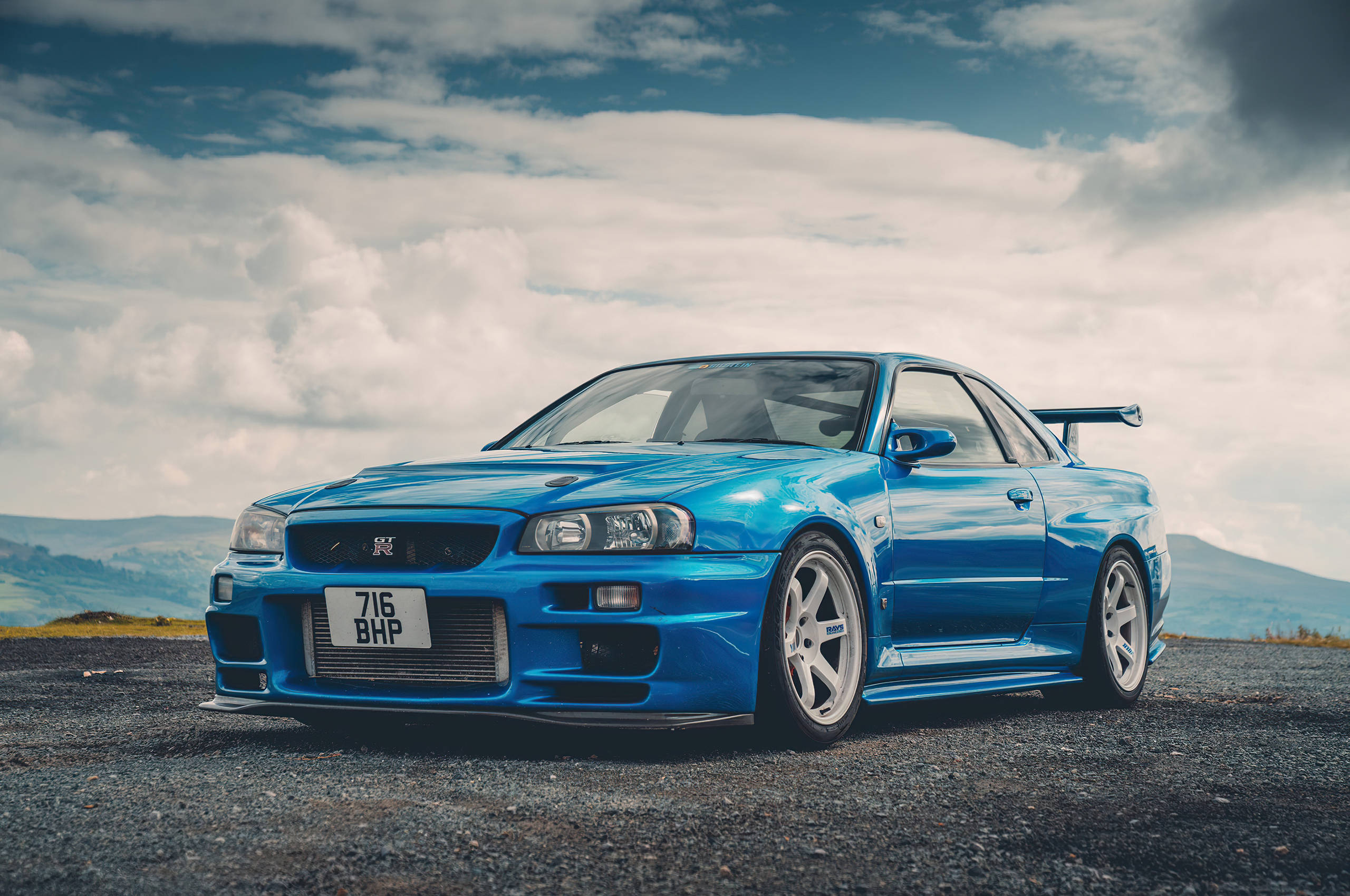 Turkoois Nissan Skyline GTR R34 Muurpapier