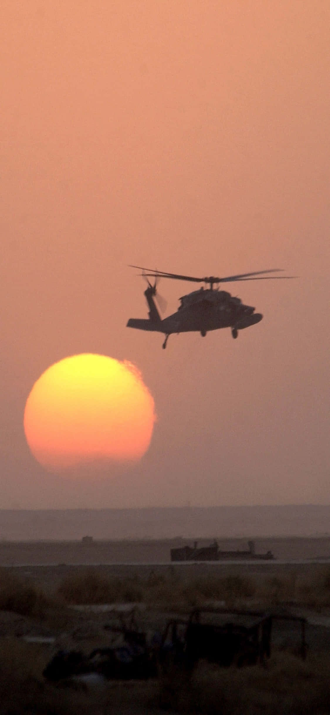 Uitsig van die iPhone Xs en sy weerkaatsing in die helikopter se venster Muurpapier