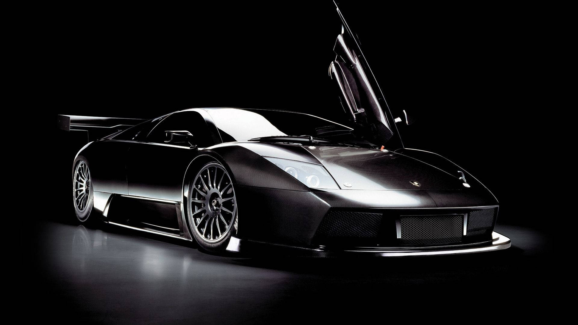 Pragtige motor muurpapier van swart Lamborghini met flapdeure. — Motor GIF Muurpapier