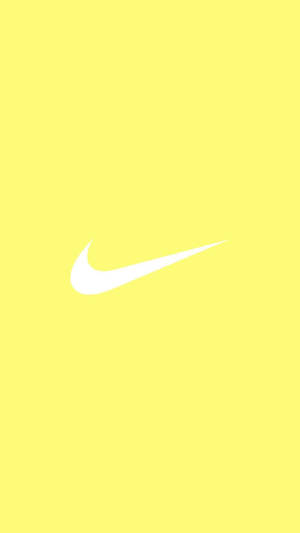 Betowerende spat van oulike pastelgeel estetika met ikoniese Nike-logo — Pastel Geel Esteties Muurpapier
