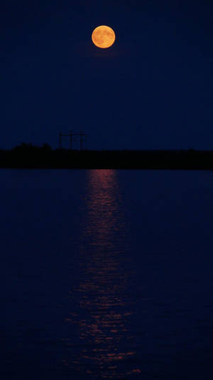 Glowende Volmaan oor die See Donkermodus