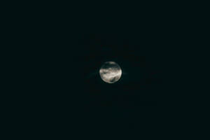 Volmaan in die donker middernaghemel. Suiwer swart buitenste ruimte met skynende maanlig.