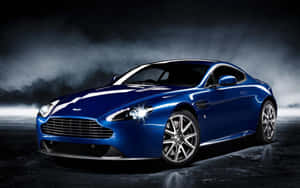Pragtige Aston Martin DB9 in beweging op 'n skilderagtige roete — Steam Deck OLED Muurpapier