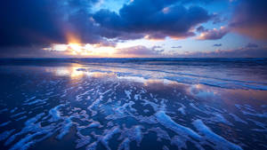 Sonsondergang op die strand Macbook-agtergrond