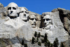 Son wat op Mount Rushmore skyn — Blou lug Muurpapier